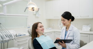 a dentist is explaining about CDCP for cosmetic dentistry for a patient.
