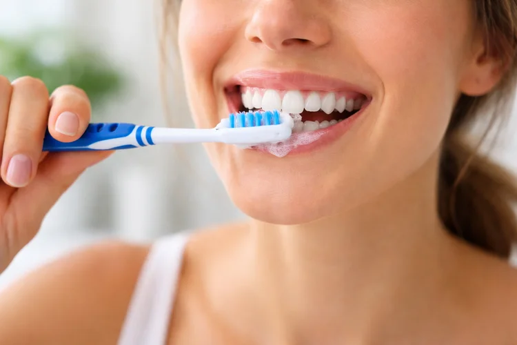 A picture of a lady brushing her teeth