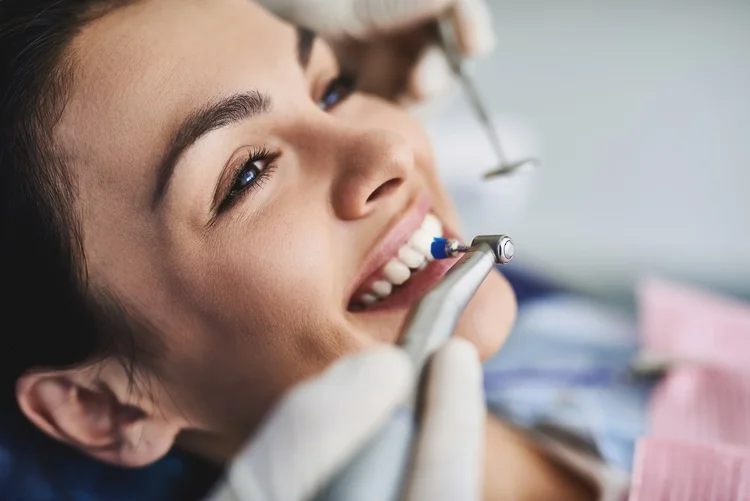 A picture of a woman getting her teeth whitened